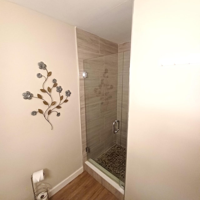 5070 Nesting Way Unit B, Delray Beach, FL 33484 - bathroom with a shower stall, wood finished floors, and baseboards