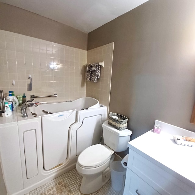 5070 Nesting Way Unit B, Delray Beach, FL 33484 - bathroom with a bath, tile patterned floors, toilet, and vanity