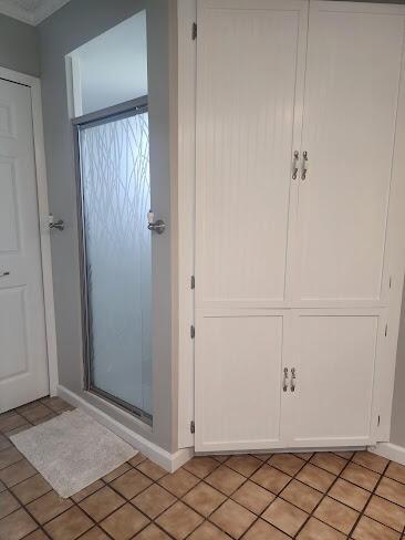 bathroom featuring tile patterned flooring and baseboards