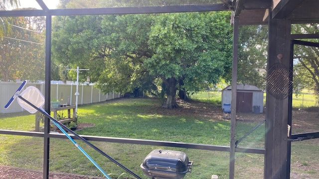 view of yard featuring a fenced backyard, a shed, and an outdoor structure