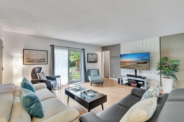 living room with a textured ceiling and wood finished floors