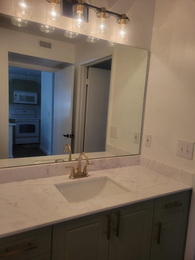 bathroom with visible vents and vanity