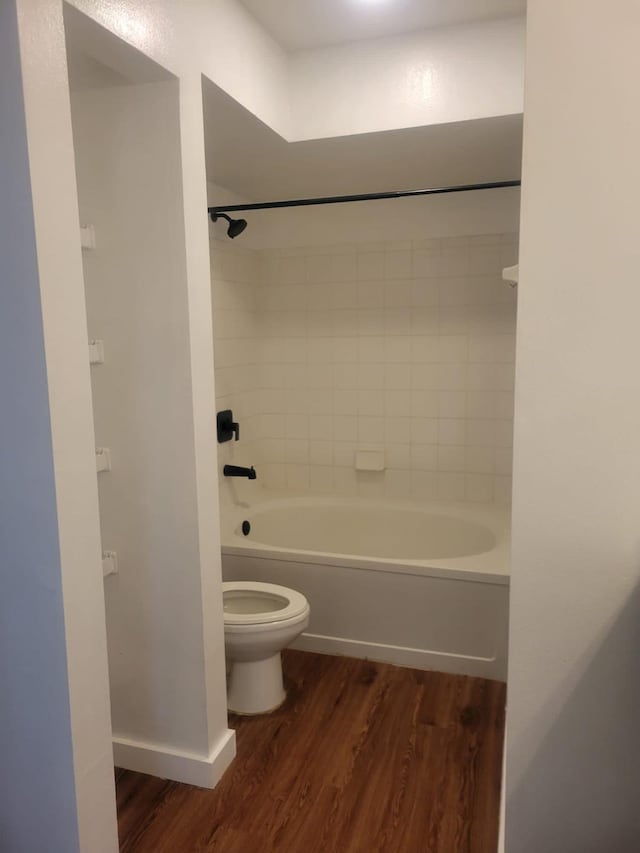 full bathroom featuring toilet, shower / tub combination, baseboards, and wood finished floors