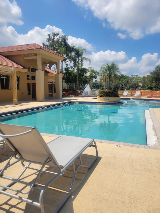 community pool with a patio area