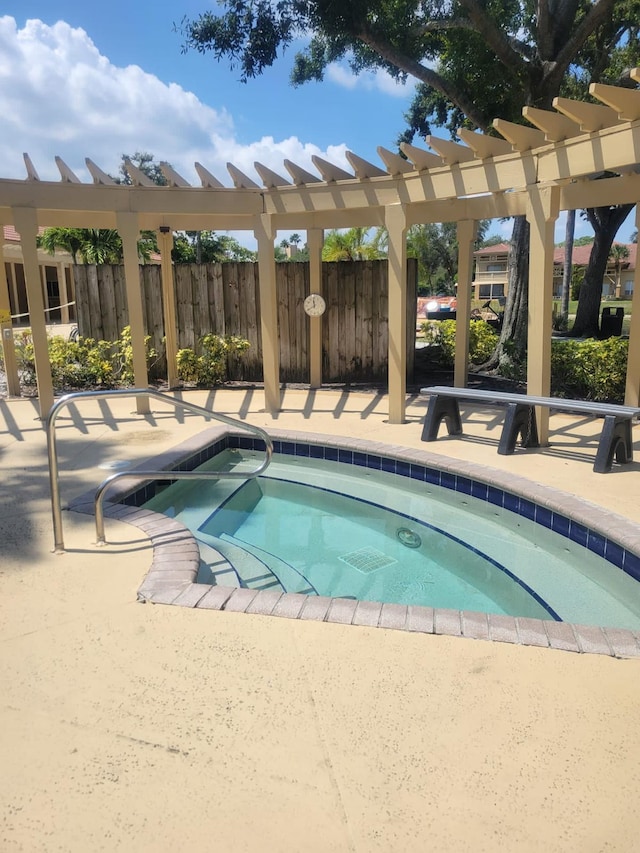 view of pool with a patio area, fence, and a community hot tub