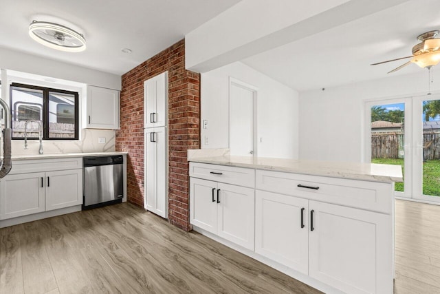 kitchen featuring light wood-style floors, white cabinetry, dishwasher, and a peninsula