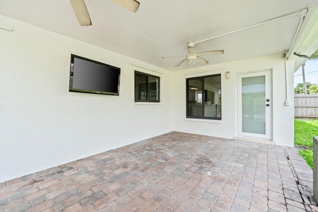 view of patio / terrace with ceiling fan and fence