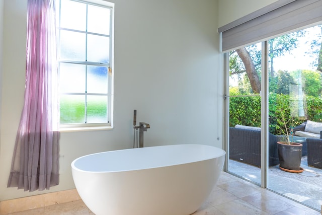 full bathroom featuring a soaking tub and tile patterned floors