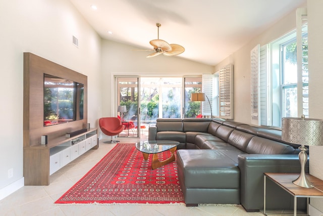 living area with light tile patterned floors, vaulted ceiling, visible vents, and a healthy amount of sunlight