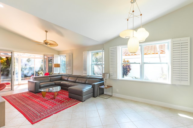 living room featuring lofted ceiling, light tile patterned flooring, a ceiling fan, and baseboards