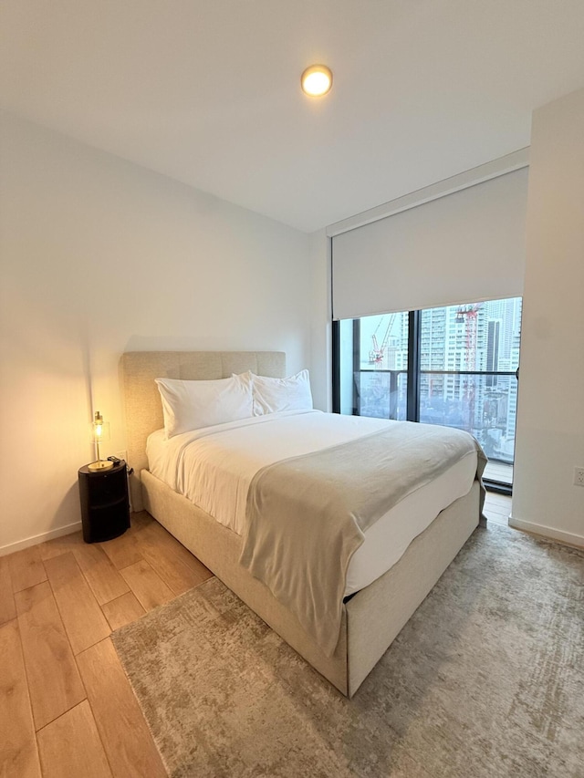 bedroom featuring baseboards and wood finished floors