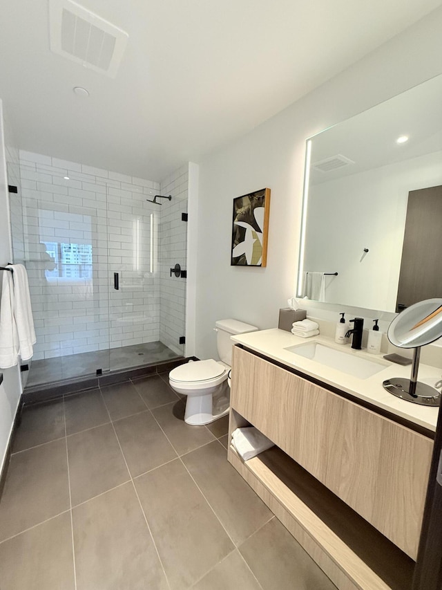 bathroom with toilet, tile patterned flooring, visible vents, and vanity