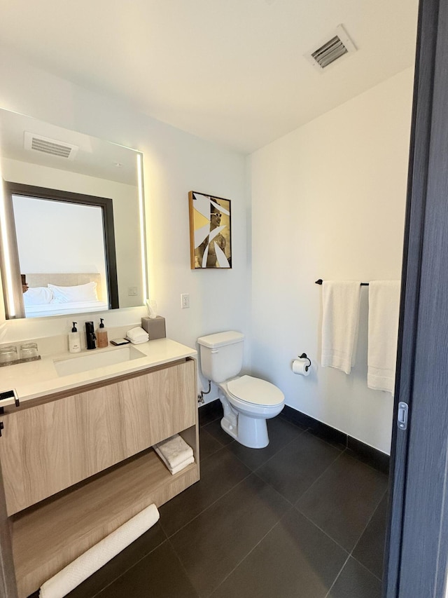 bathroom with toilet, tile patterned floors, visible vents, and vanity