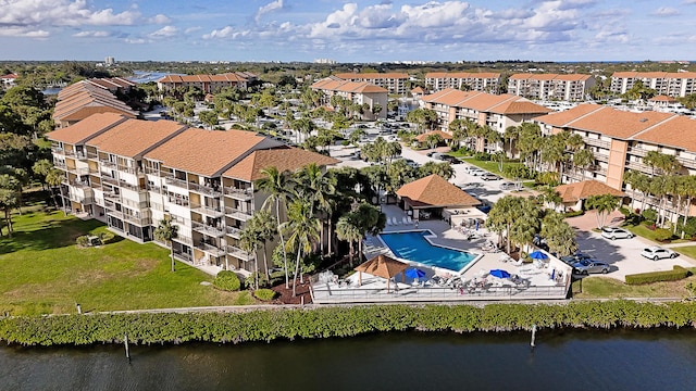 drone / aerial view featuring a water view and a residential view