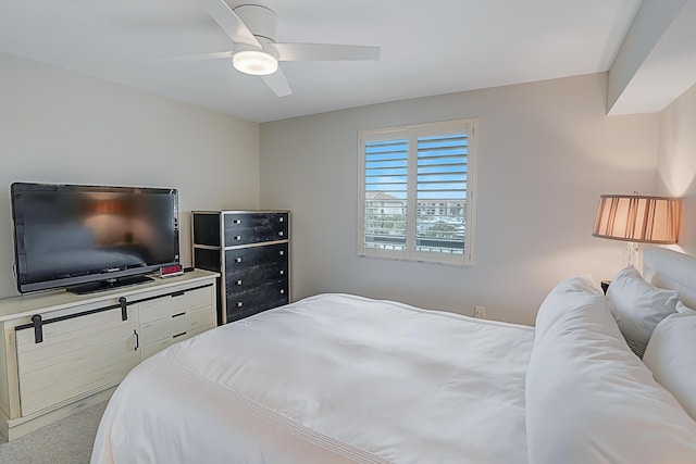 bedroom featuring a ceiling fan and light carpet