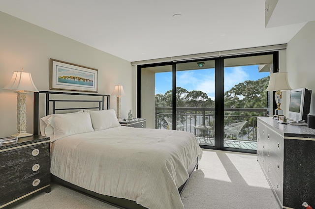 bedroom with light carpet, access to outside, and floor to ceiling windows