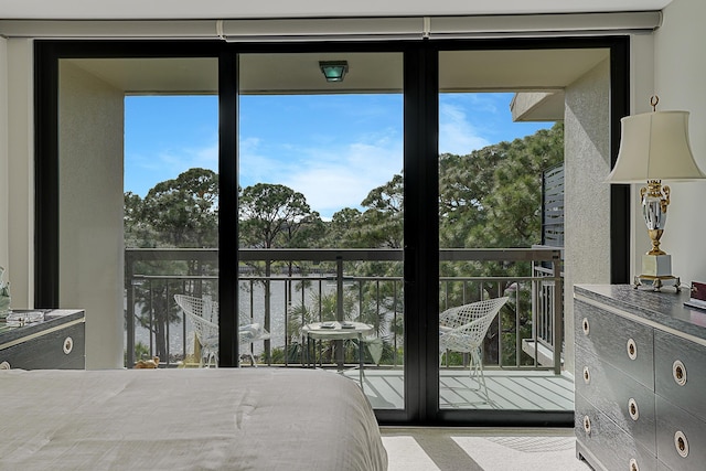 unfurnished bedroom with a water view and floor to ceiling windows