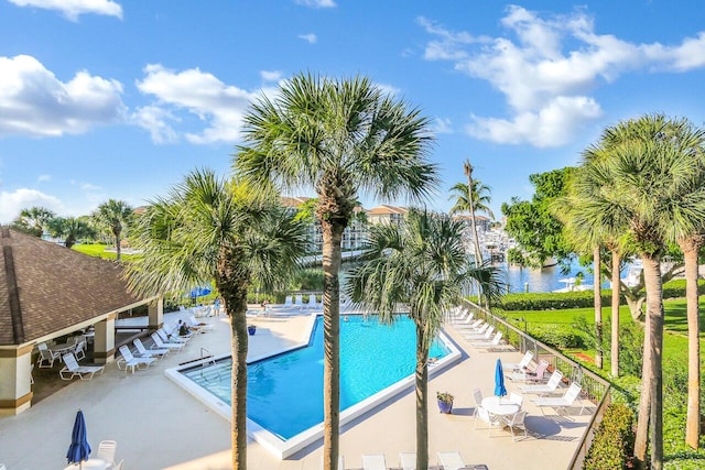 pool featuring a gazebo, a patio area, and a water view