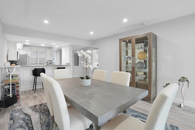 dining area featuring light wood-type flooring, baseboards, and recessed lighting