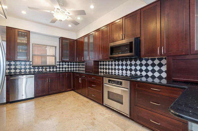 kitchen featuring glass insert cabinets, stainless steel appliances, and backsplash