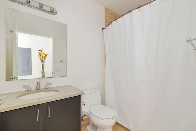 bathroom featuring toilet, electric panel, a shower with shower curtain, and vanity