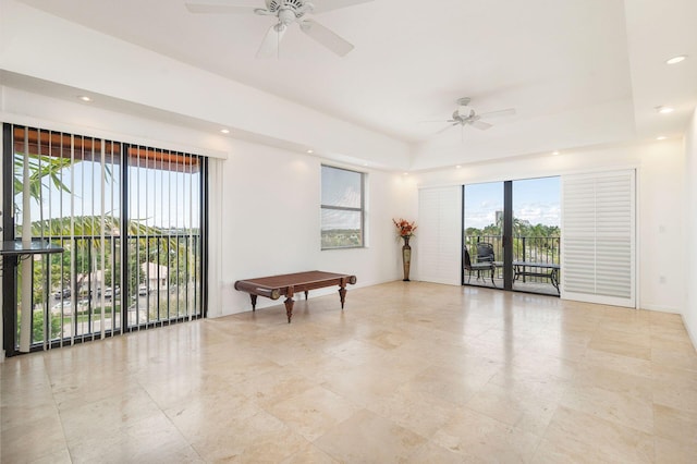 unfurnished room with baseboards, a raised ceiling, a ceiling fan, and recessed lighting