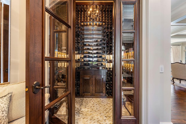 wine cellar with electric panel and an inviting chandelier