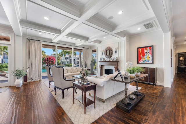 living room featuring visible vents, beam ceiling, coffered ceiling, a fireplace, and a healthy amount of sunlight