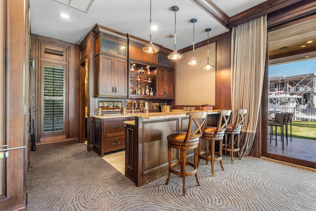 bar featuring indoor wet bar, visible vents, and hanging light fixtures