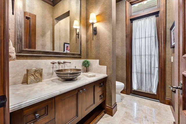 bathroom featuring toilet and vanity