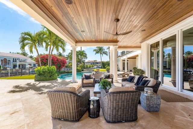 view of patio / terrace featuring an outdoor pool, outdoor lounge area, and fence