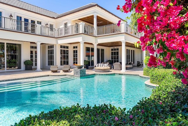 pool featuring french doors, an outdoor hangout area, and a patio area