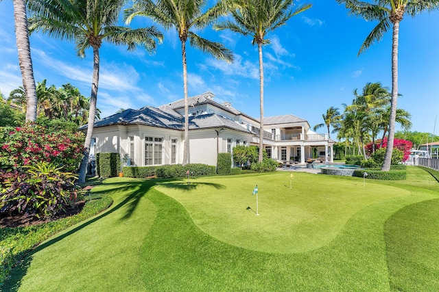 back of property featuring a patio, fence, and an outdoor pool