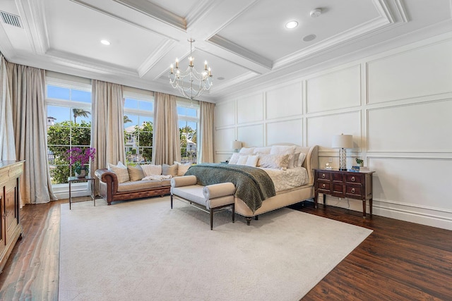 bedroom featuring ornamental molding, an inviting chandelier, a decorative wall, coffered ceiling, and dark wood-style flooring