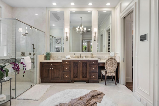 bathroom featuring vanity, recessed lighting, ornamental molding, a shower stall, and a chandelier