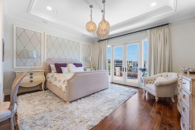 bedroom with crown molding, dark wood-type flooring, french doors, a raised ceiling, and access to outside