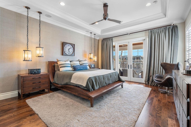 bedroom featuring ornamental molding, access to exterior, dark wood-type flooring, french doors, and a raised ceiling