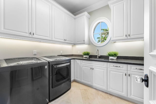 washroom featuring ornamental molding, a sink, cabinet space, light tile patterned floors, and washing machine and clothes dryer