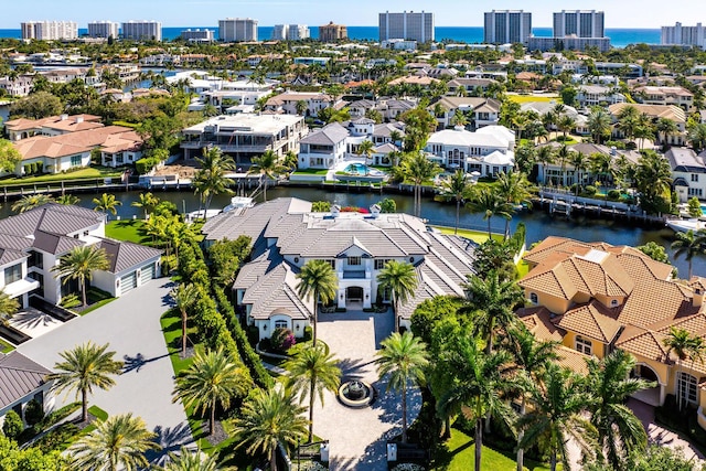 drone / aerial view featuring a residential view and a water view