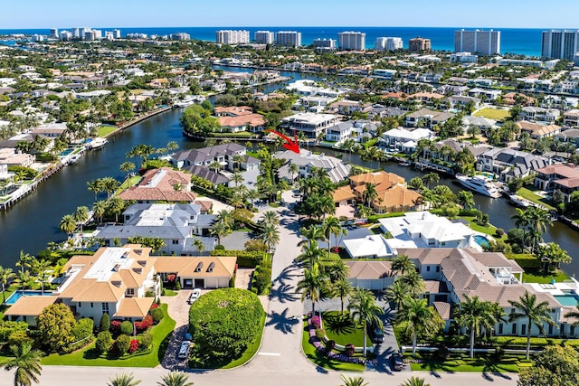 drone / aerial view featuring a residential view and a water view