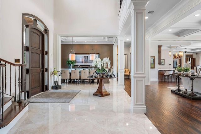 entryway featuring stairway, visible vents, decorative columns, crown molding, and marble finish floor