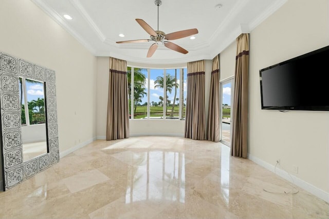 unfurnished living room with marble finish floor, baseboards, ornamental molding, and a raised ceiling