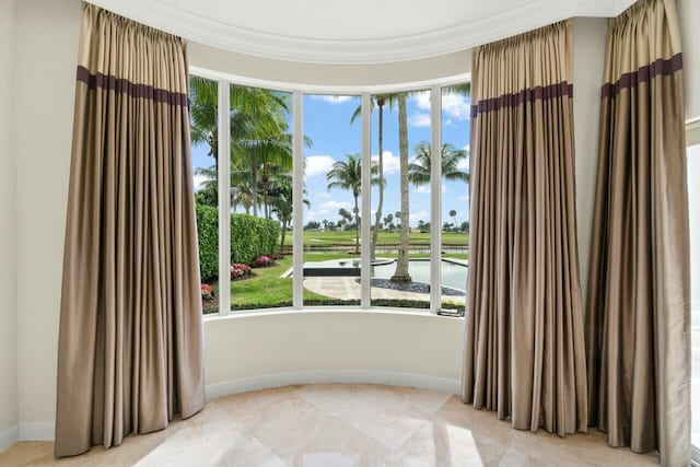 spare room with plenty of natural light and baseboards