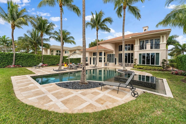 view of pool with a yard, a patio area, fence, and a fenced in pool