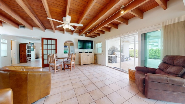 living room with ceiling fan, light tile patterned flooring, visible vents, wood ceiling, and beamed ceiling