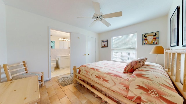 bedroom featuring connected bathroom, light wood-style flooring, and ceiling fan