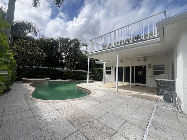 view of swimming pool with a patio, a pool with connected hot tub, area for grilling, and a ceiling fan