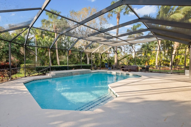 pool featuring glass enclosure and a patio