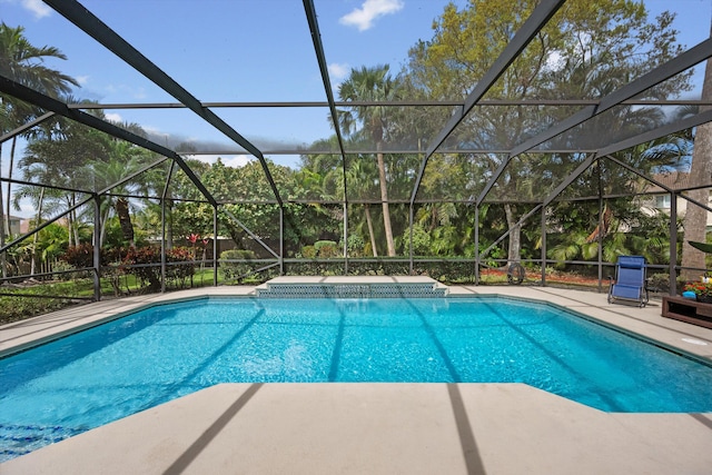 pool with a patio area and glass enclosure