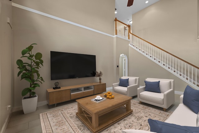 living area with stairs, baseboards, arched walkways, recessed lighting, and ceiling fan